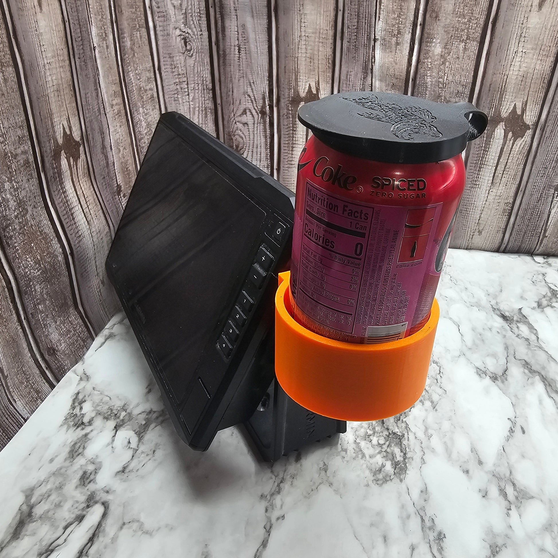 Photo showing the drink holder holding a can of soda from the side