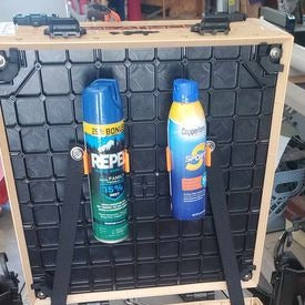 Photo of two can clips installed and holding spray cans