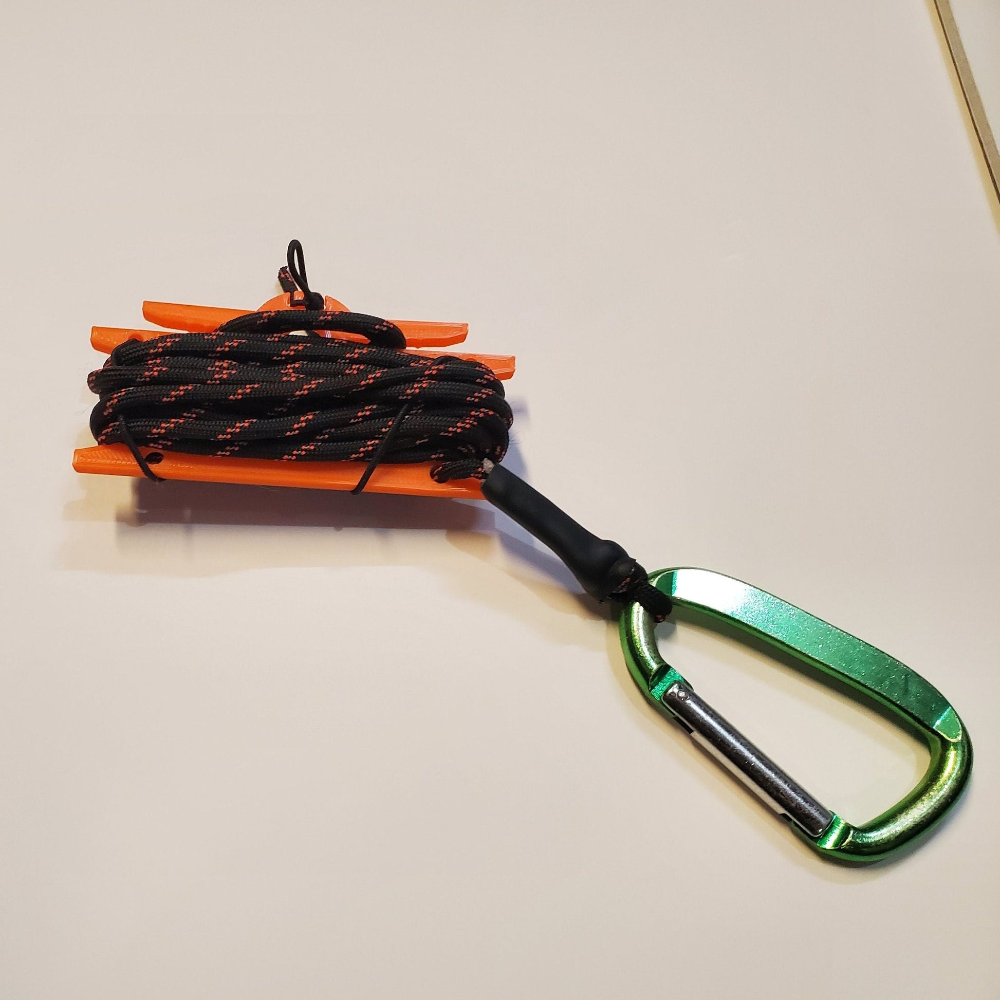Image of a cord winder with cord and a carabiner