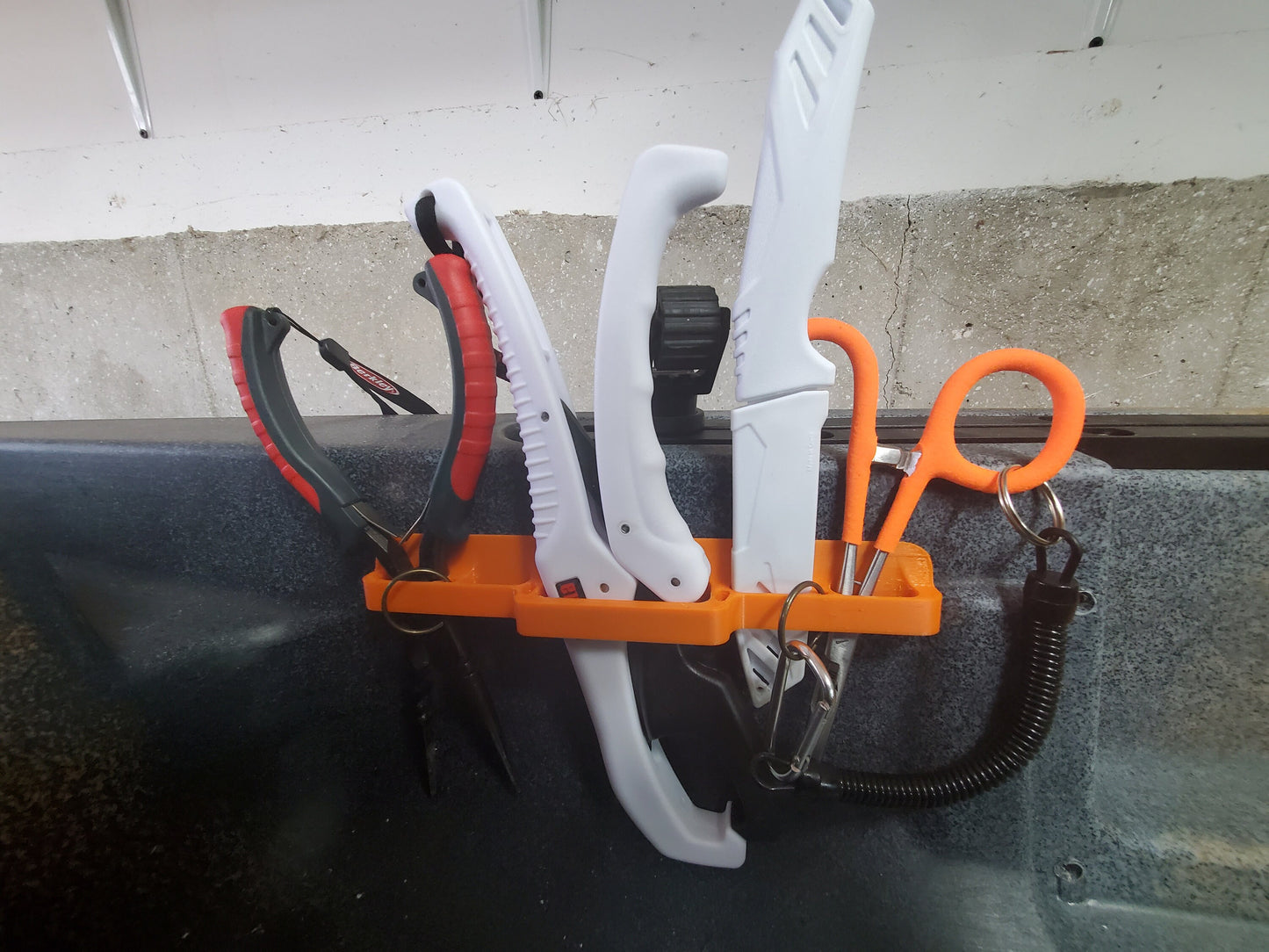 image of universal toool holder mounted on a kayak with tools
