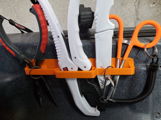Photo of the universal tool holder holding tools on a kayak