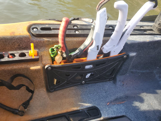 Photo of the inside pocket tool holder mounted in a kayak holding tools
