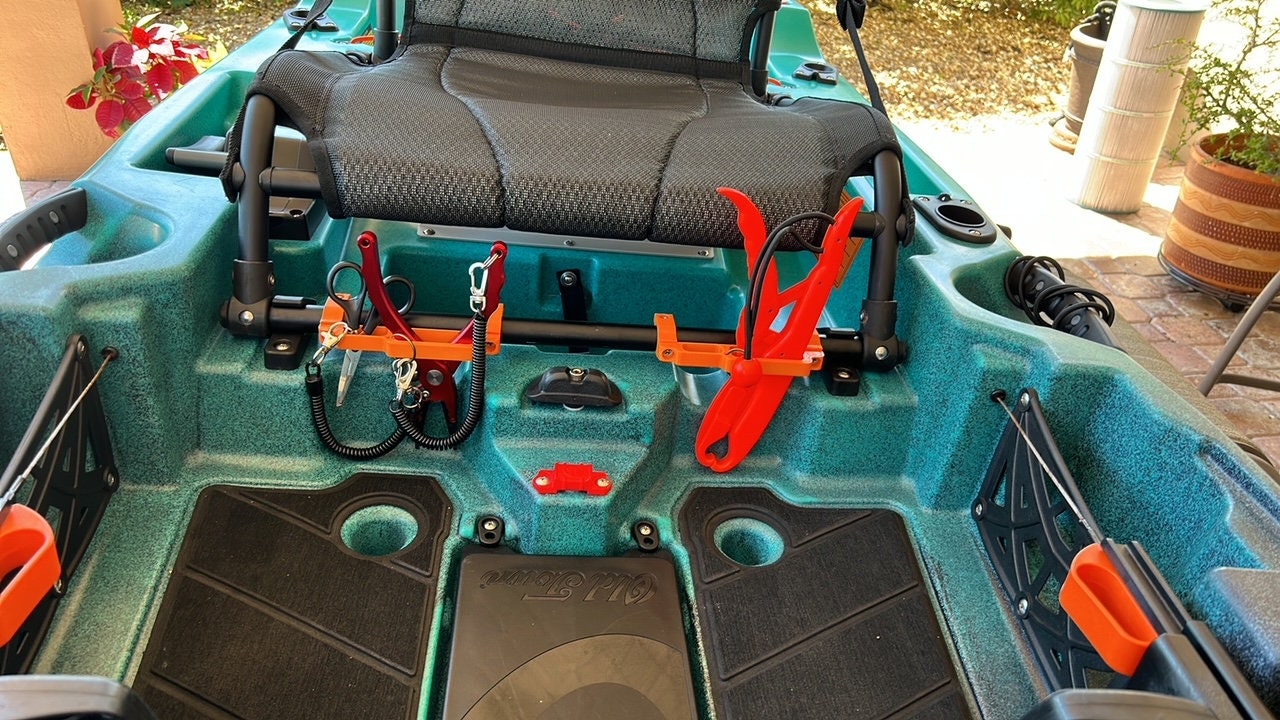 Photo of tool holders on seat crossbar holding tools