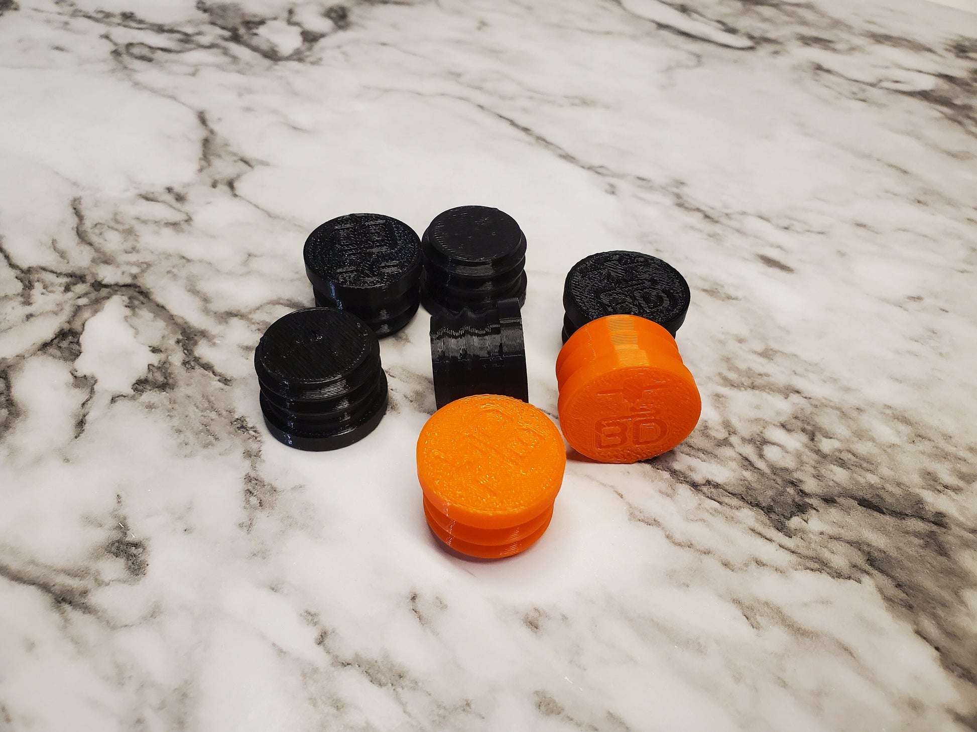 image of several black and orange blexible end caps